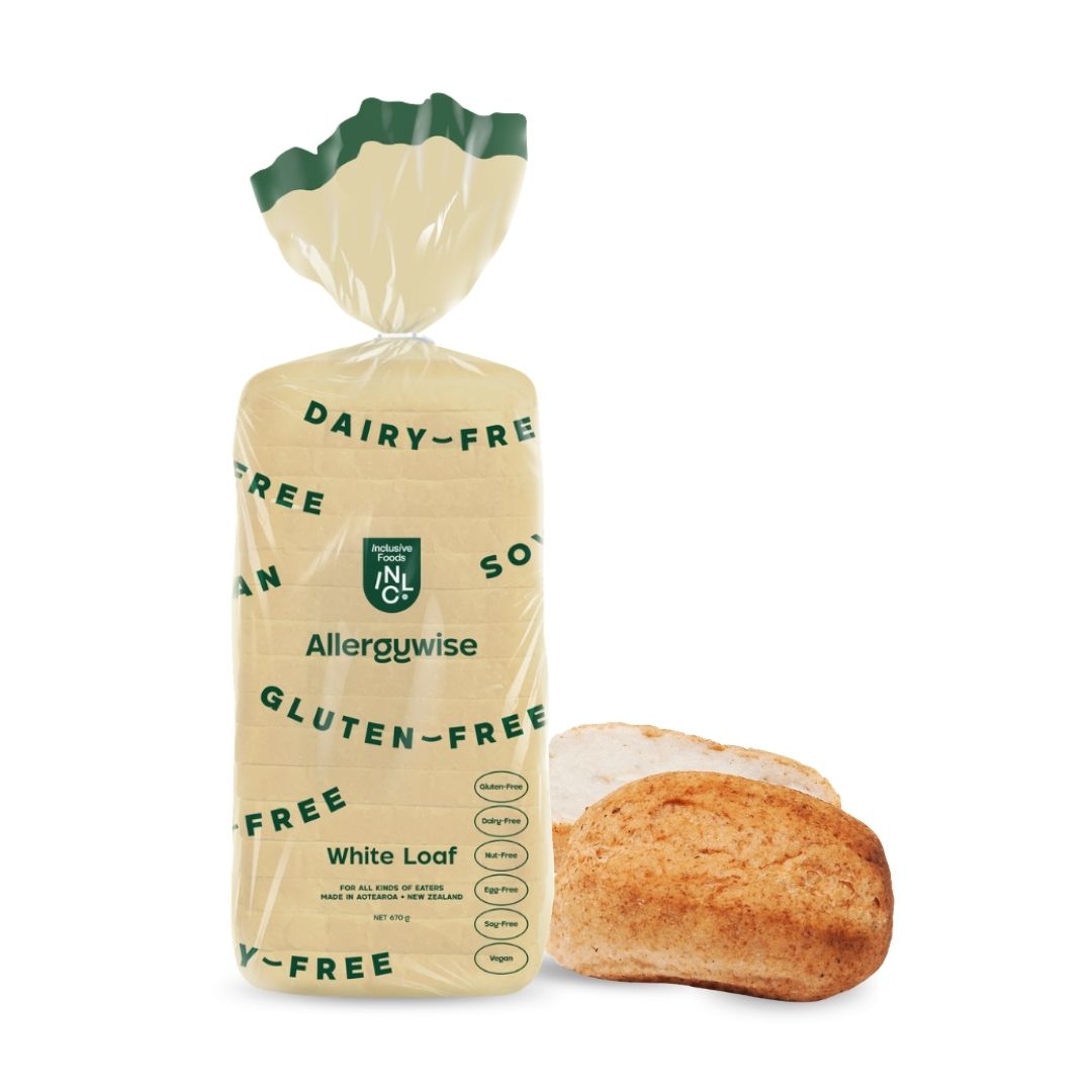 Packaged loaf of bread next to a sliced white roll on a white background. The bread is labeled Dairy-Free, Gluten-Free, and Allergywise.